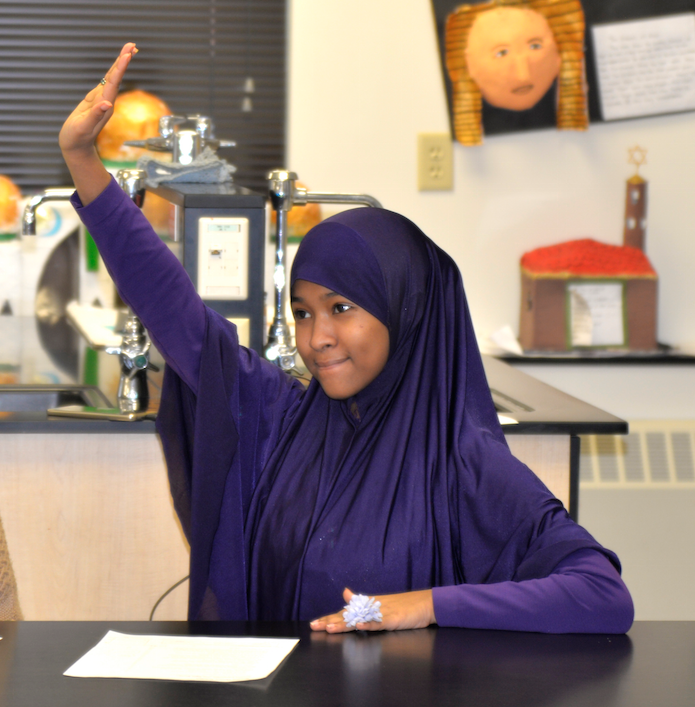 Raising her hand in class 